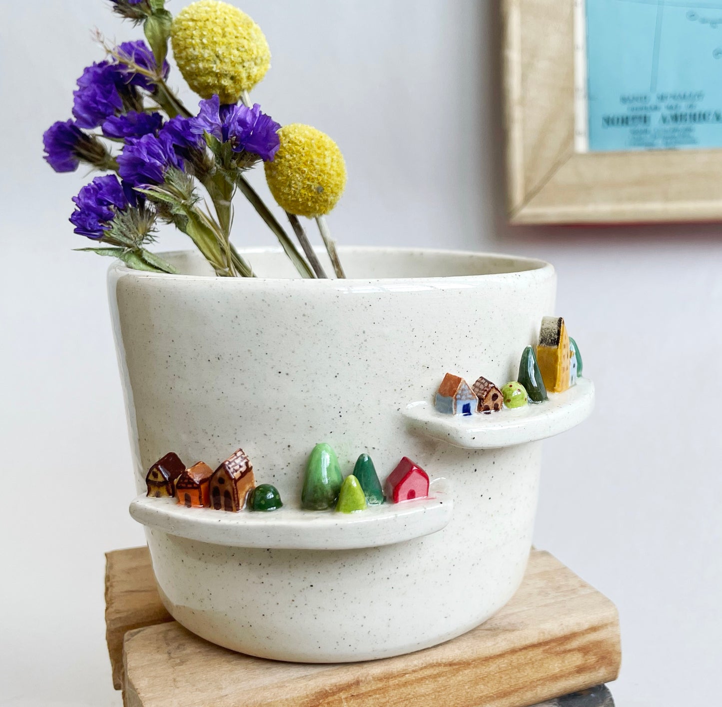 Cream planter with tiny houses and trees