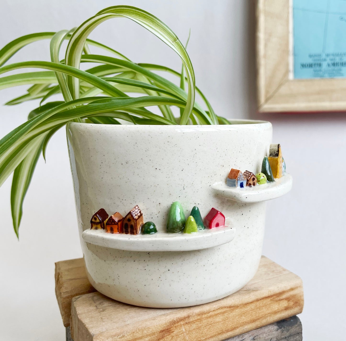 Cream planter with tiny houses and trees